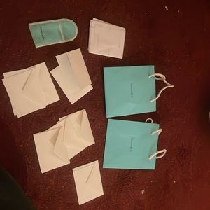 2 bags, tissue paper, little bag, and 7 engraved blank cards. Includes all.